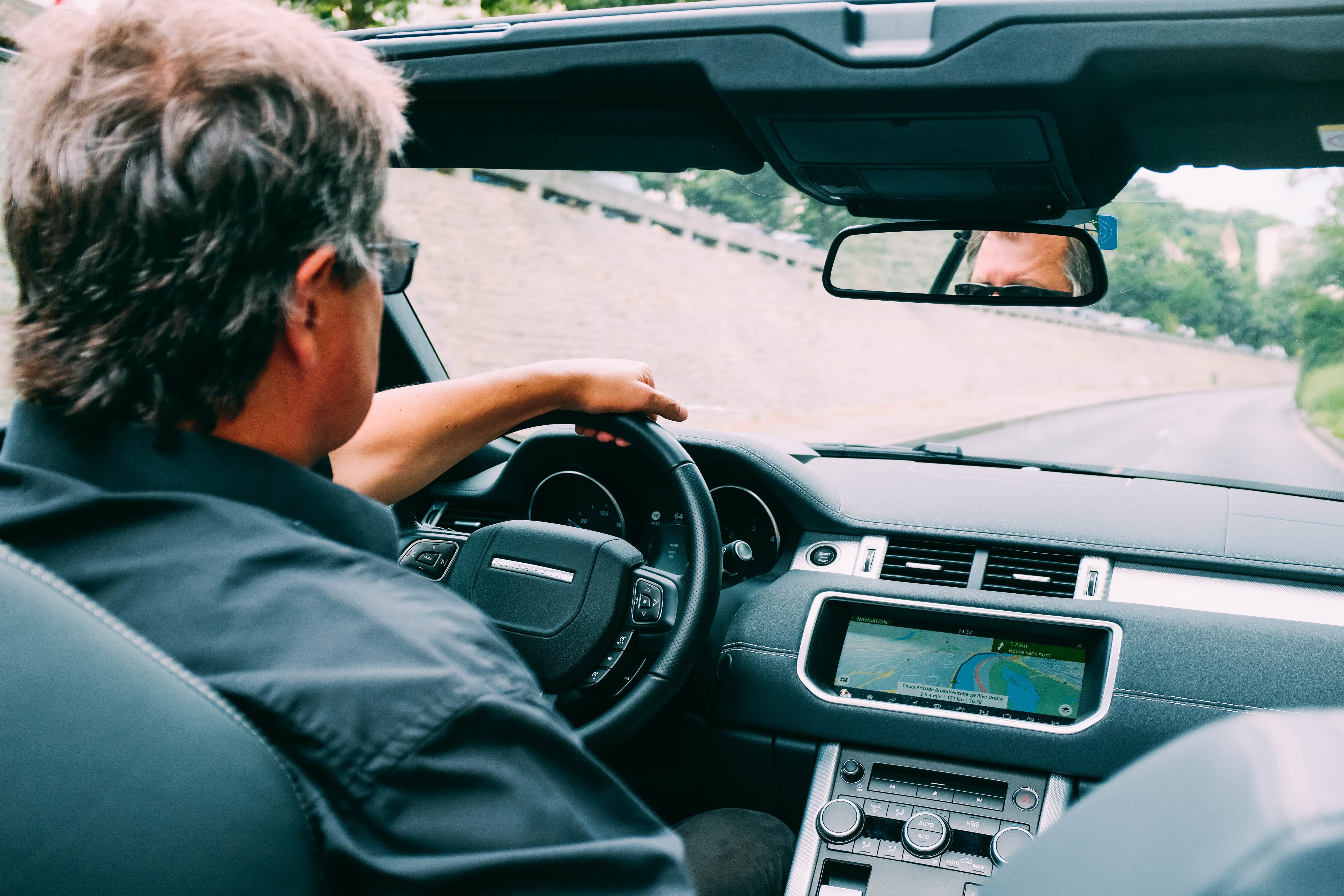 Man driving convertible car