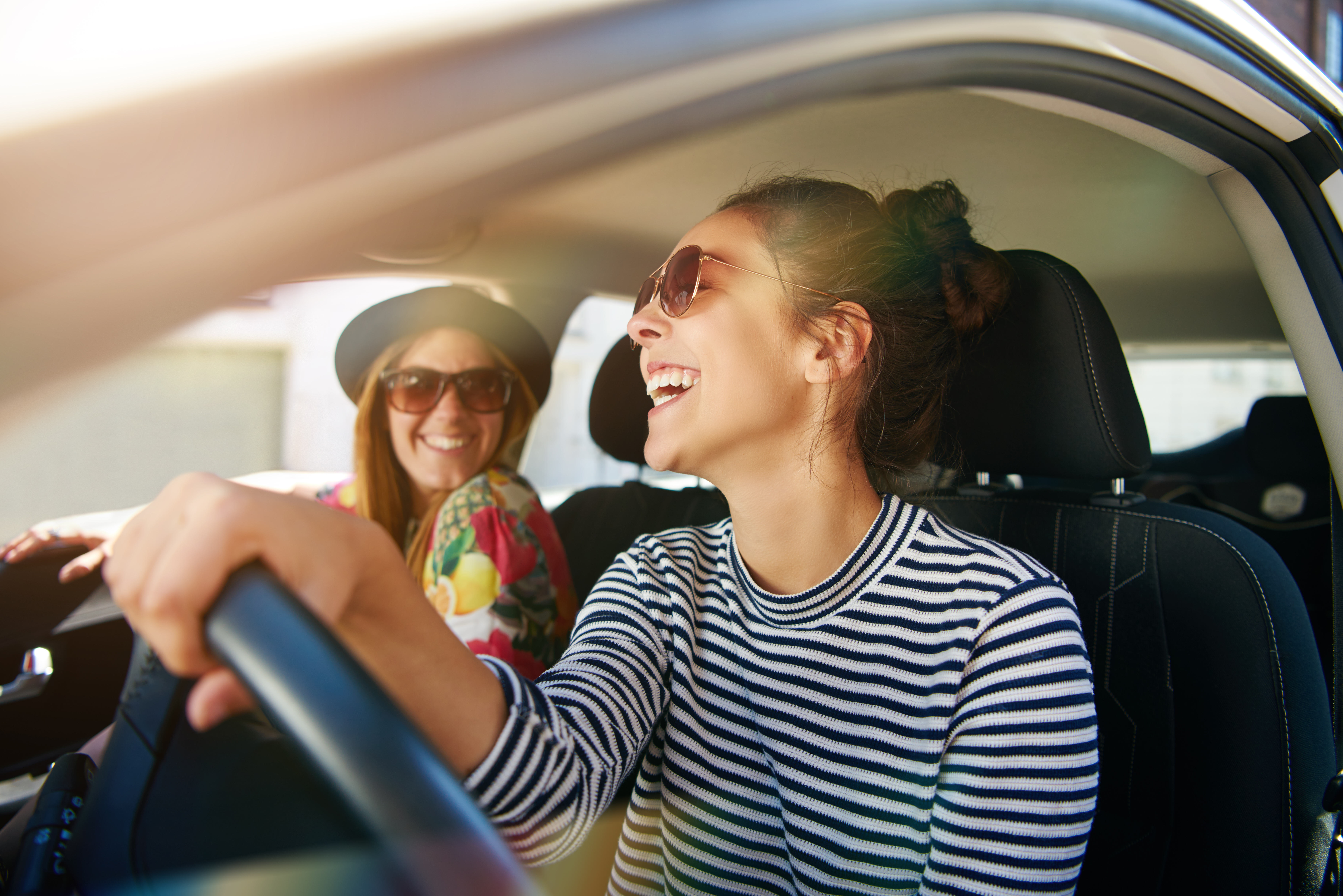 Two women smiling in car