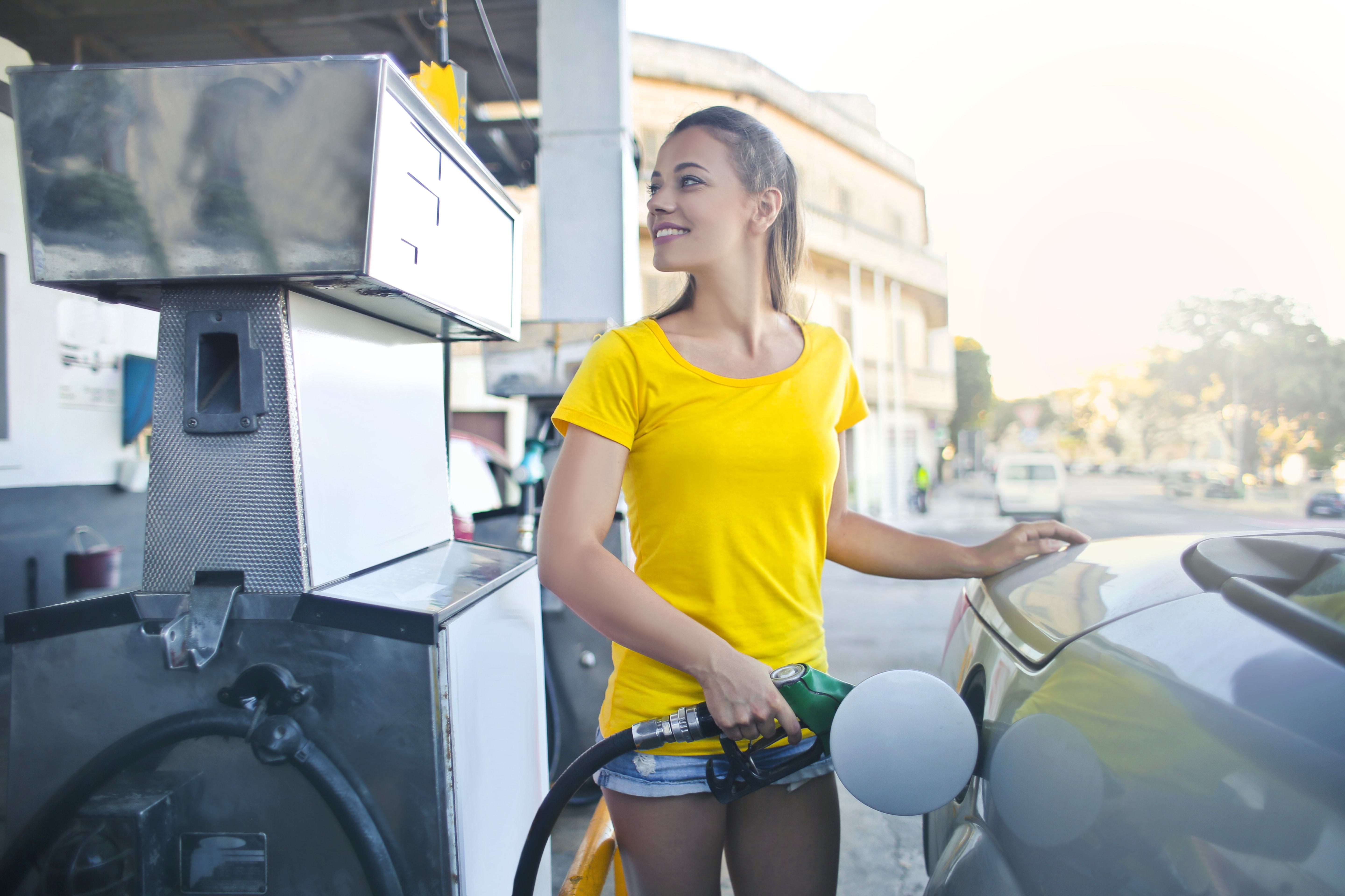 Woman filling up car with fuel